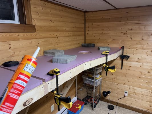 Gluing down the first foam panel, day 6 of benchwork construction